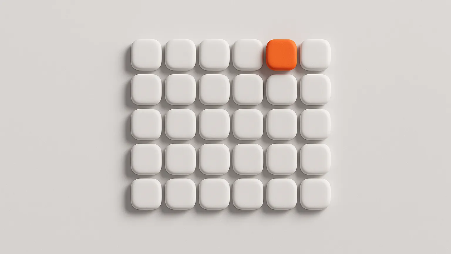 A grid of small white tiles with one orange tile raised above the rest